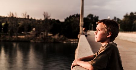 Boy Pondering on Bridge small